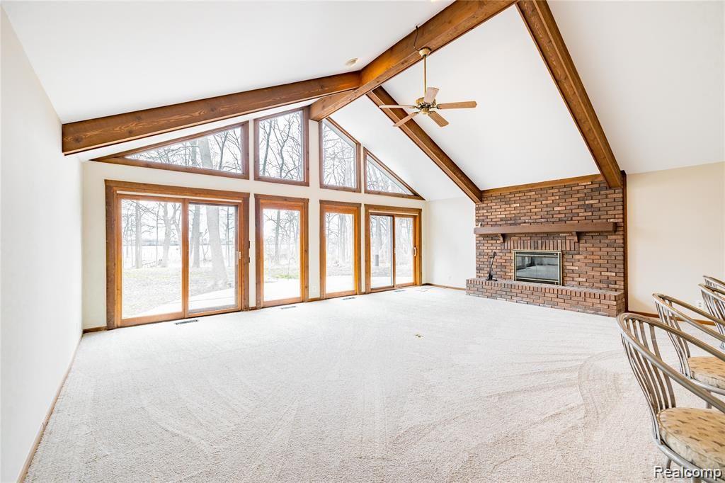 19130 Meridian Road Grosse Ile, MI 48138 - Photo 11 of 49 Vaulted ceilings, new carpeting, freshly painted - with a natural fireplace as well.