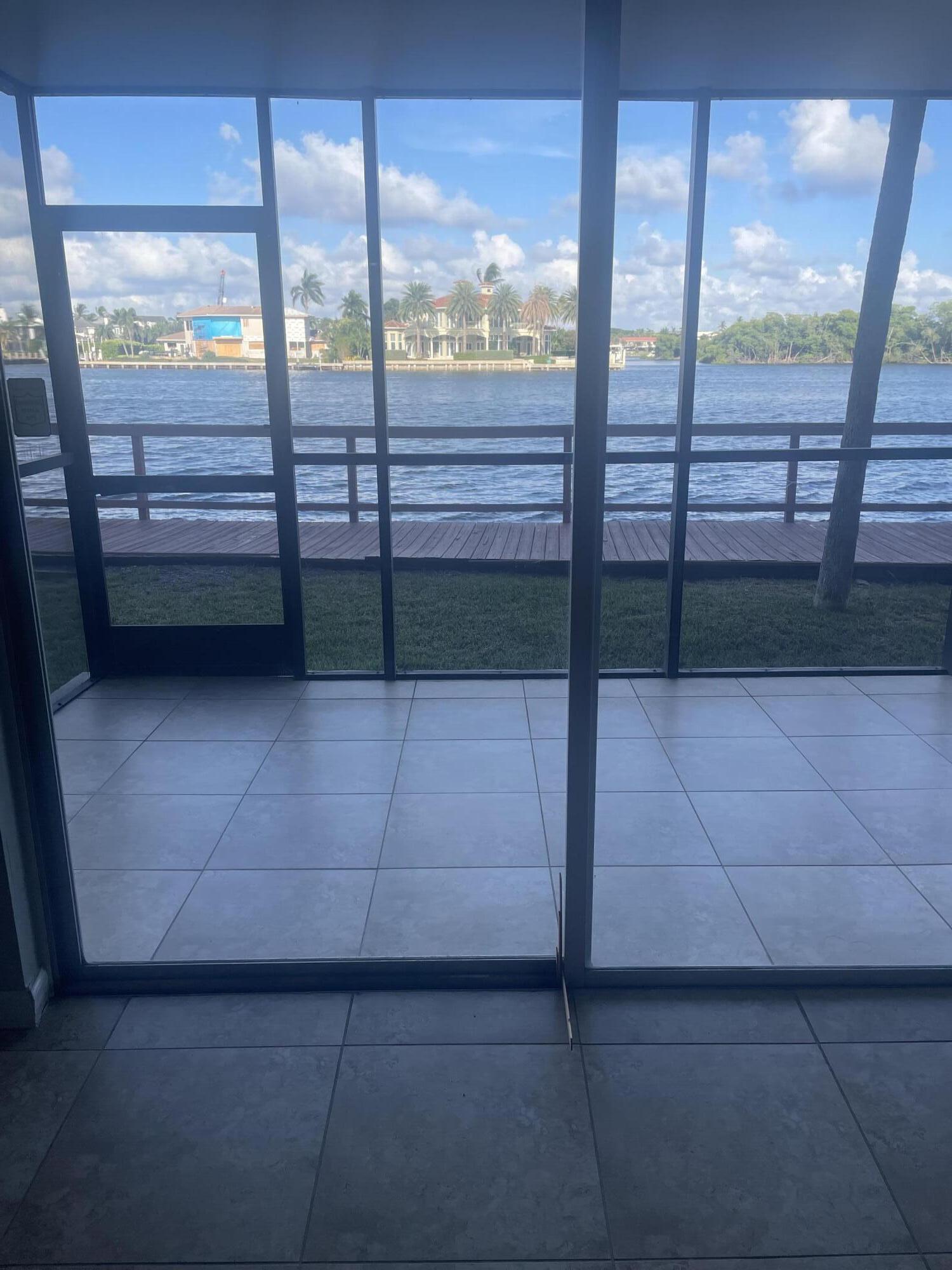 710 Northeast 7th Street, Unit 103 Boynton Beach, FL 33435 - Photo 2 of 12 a view of a glass door with a yard