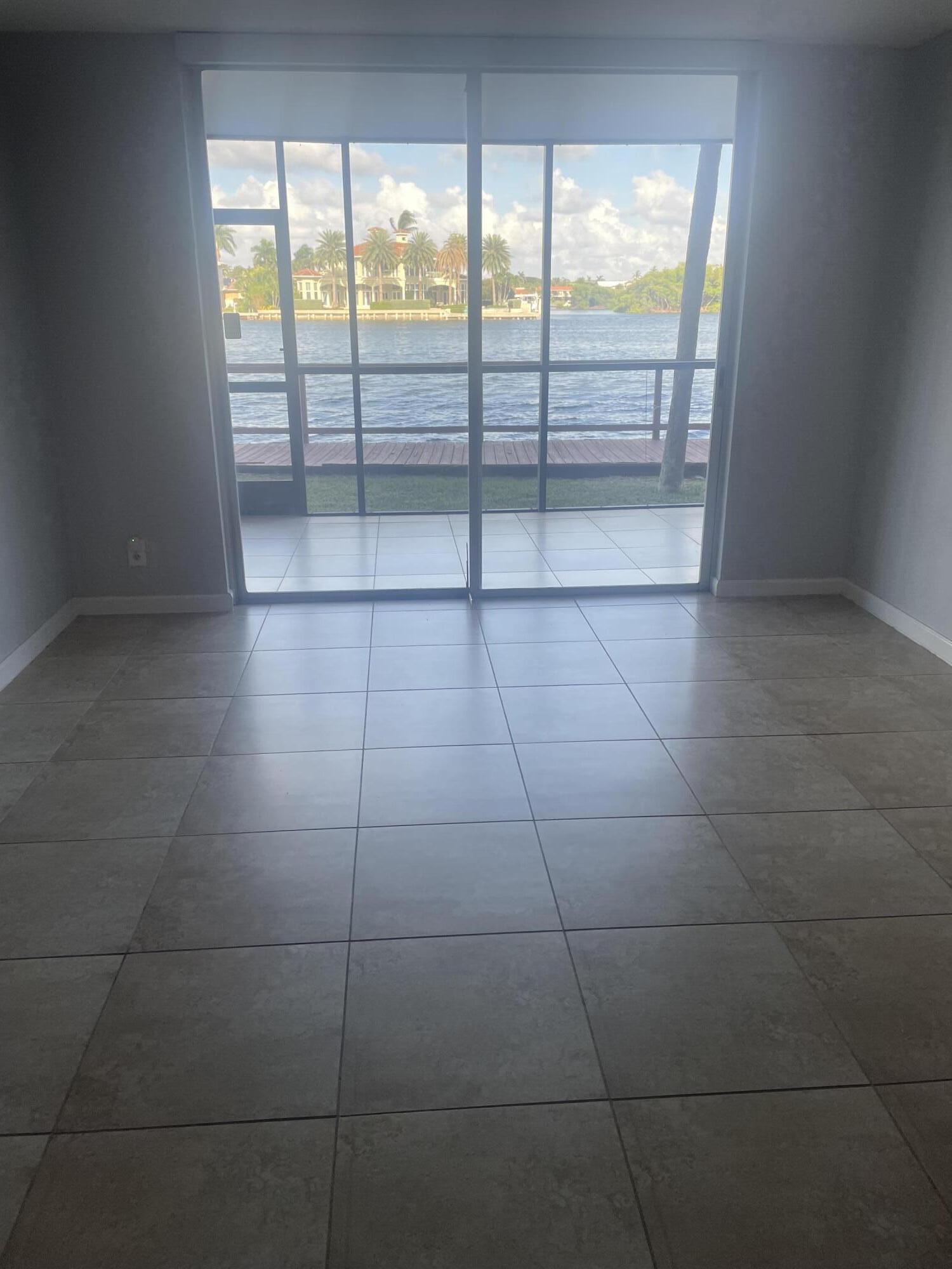 710 Northeast 7th Street, Unit 103 Boynton Beach, FL 33435 - Photo 3 of 12 a view of an empty room and window