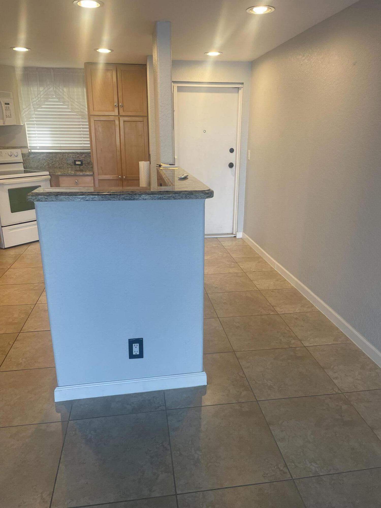 710 Northeast 7th Street, Unit 103 Boynton Beach, FL 33435 - Photo 5 of 12 a view of a kitchen with a sink