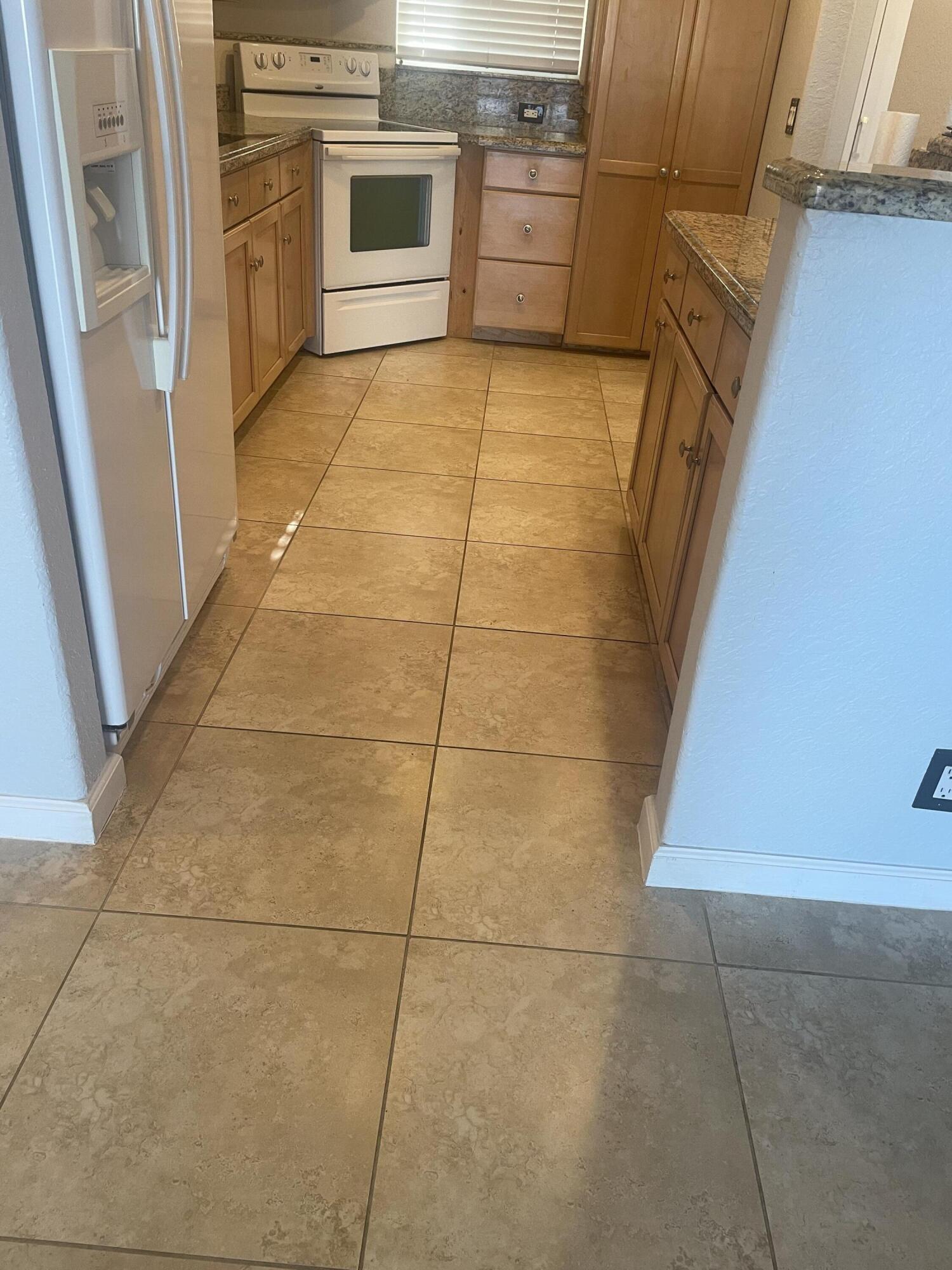 710 Northeast 7th Street, Unit 103 Boynton Beach, FL 33435 - Photo 6 of 12 a view of a kitchen with a sink stove and door