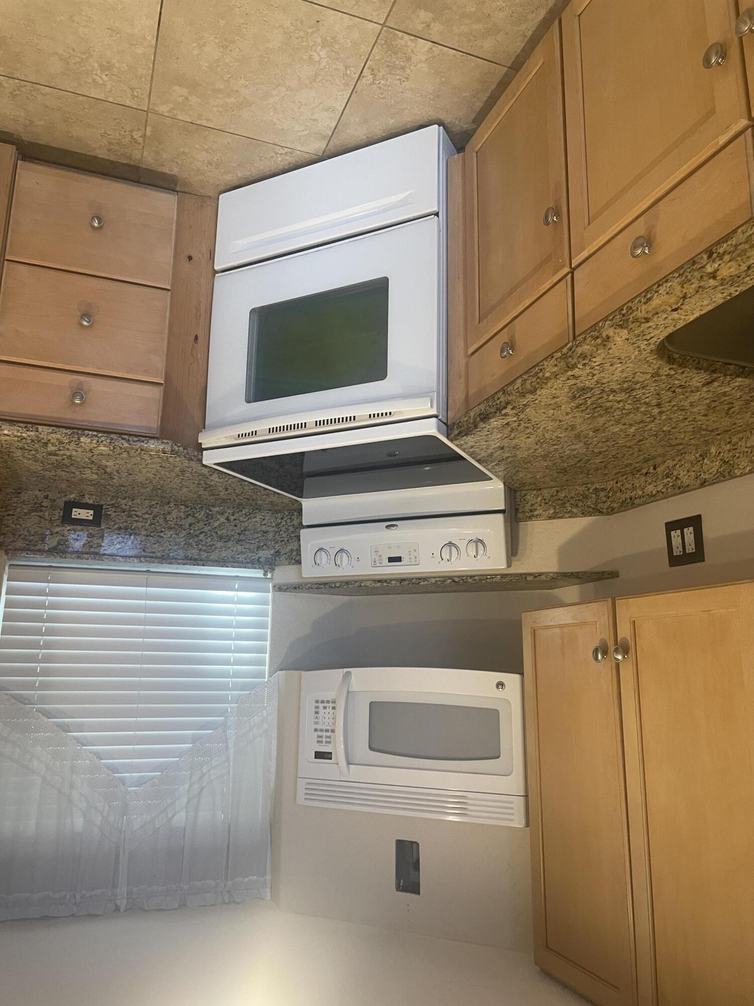 710 Northeast 7th Street, Unit 103 Boynton Beach, FL 33435 - Photo 7 of 12 a stove top oven sitting inside of a kitchen