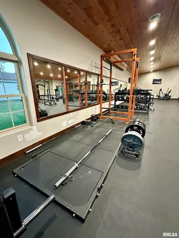 a kitchen with granite countertop a refrigerator and a stove top oven