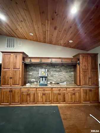 a living room with game table and a flat screen tv