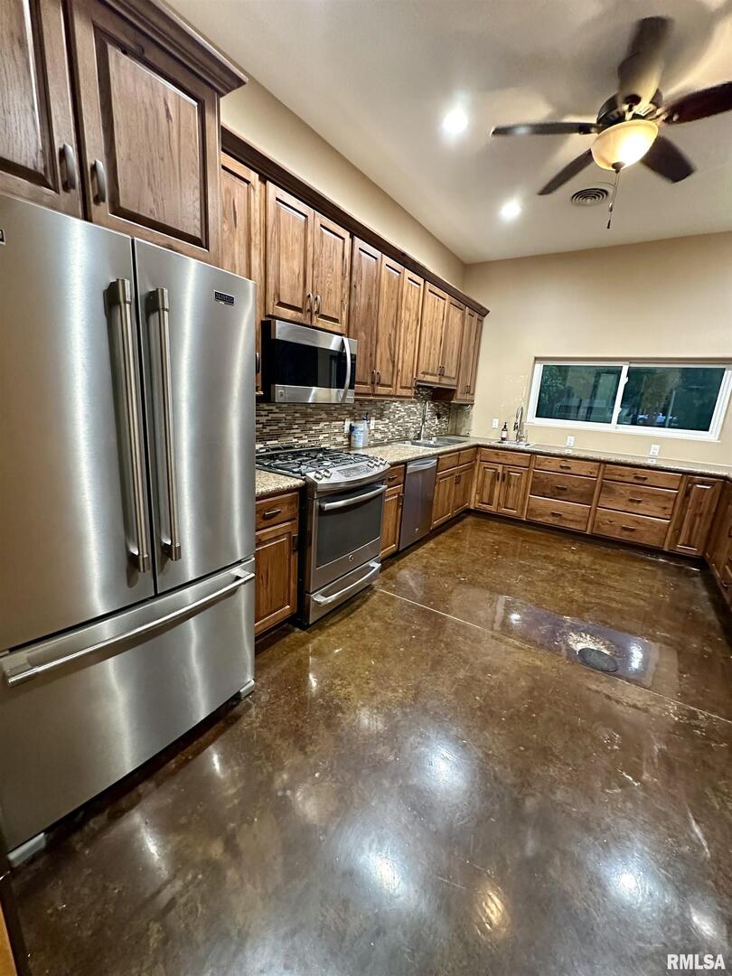 20 Ashley Lane Casey, IL 62420 - Photo 20 of 98 a kitchen with stainless steel appliances granite countertop a refrigerator a stove a sink and a microwave