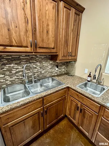a living room with hard wood floors and a ceiling fan
