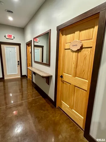 a kitchen with stainless steel appliances wooden cabinet and glass door