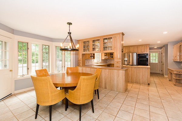 8 Old Town Road Beverly, MA 01915 - Photo 6 of 24 a dining room with furniture a chandelier and fireplace