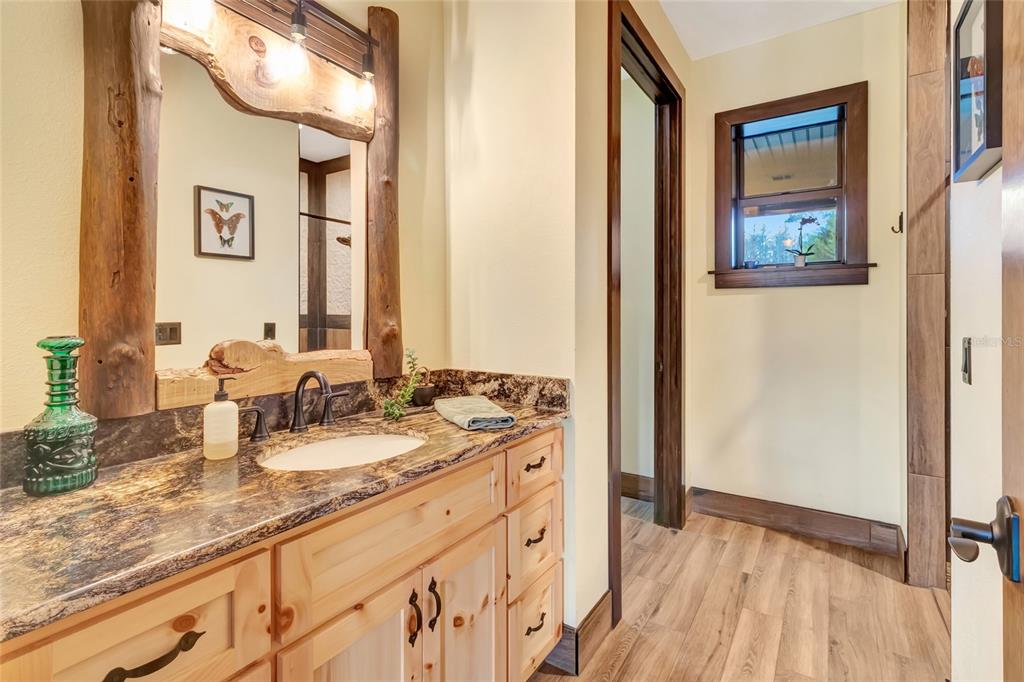 7330 Crabgrass Road St. Cloud, FL 34773 - Photo 24 of 60 a bathroom with a granite countertop sink and a mirror
