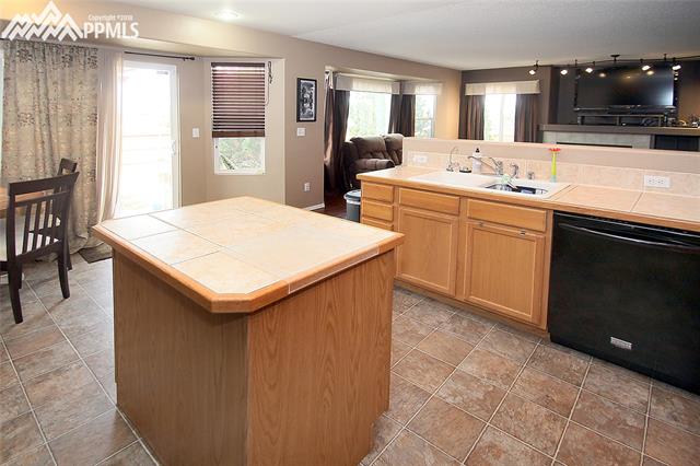 4696 Fencer Road Colorado Springs, CO 80911 - Photo 4 of 33 Kitchen view #3 walk out to large fenced back yard