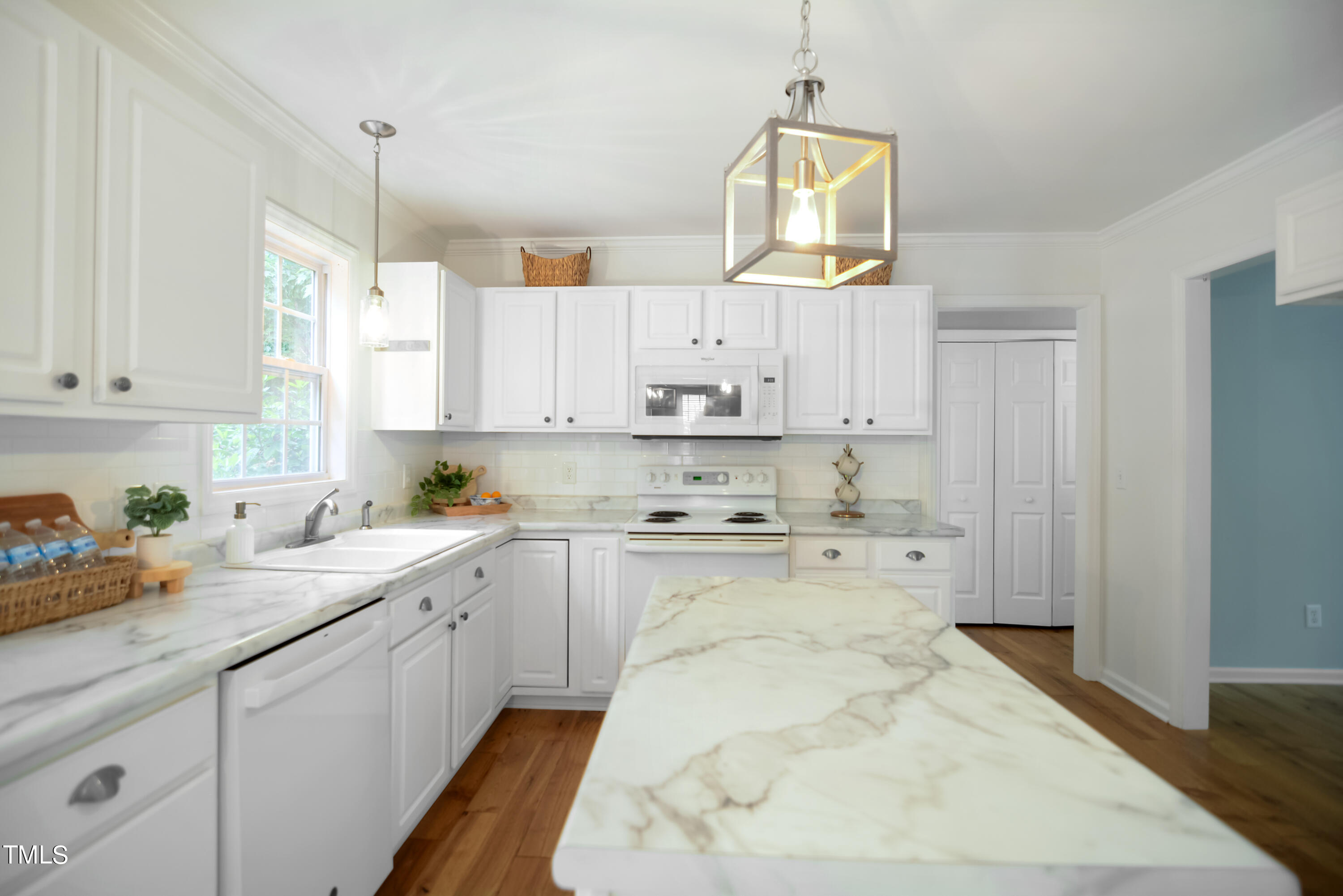 2515 Tryon Pines Drive Raleigh, NC 27603 - Photo 12 of 27 a kitchen with kitchen island white cabinets and white appliances