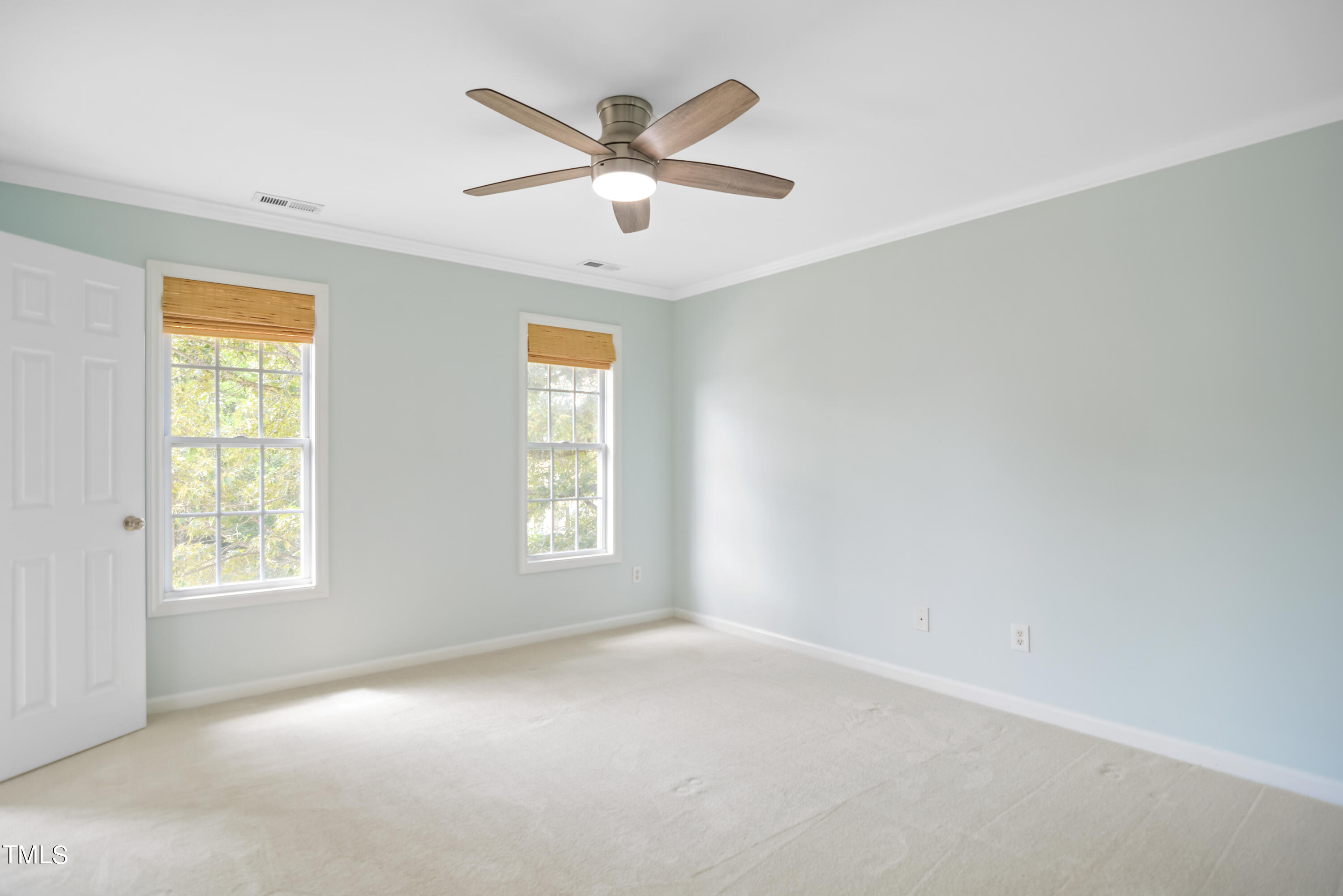2515 Tryon Pines Drive Raleigh, NC 27603 - Photo 14 of 27 an empty room with windows and fan