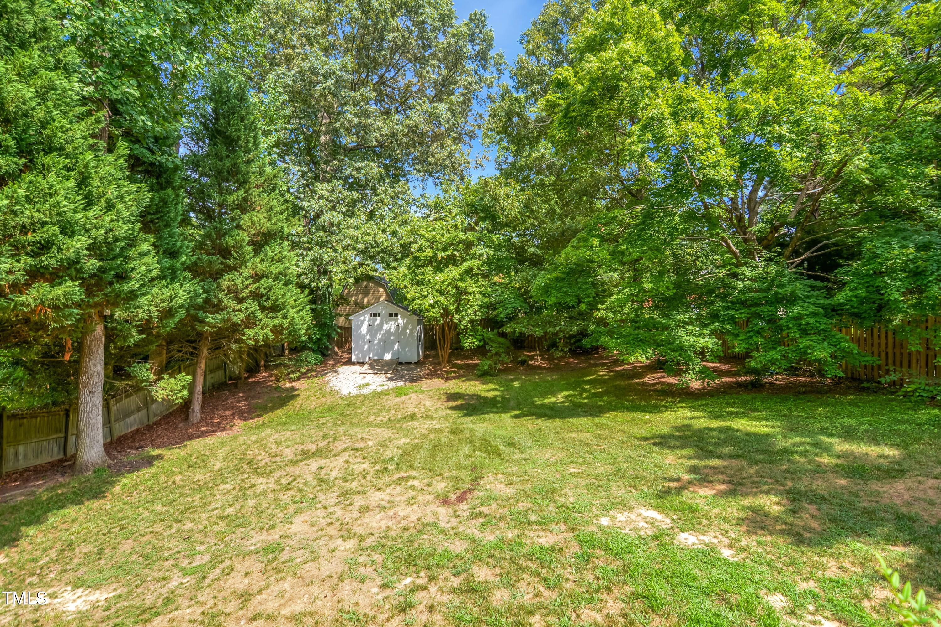 2515 Tryon Pines Drive Raleigh, NC 27603 - Photo 24 of 27 a backyard of a house with yard and tree