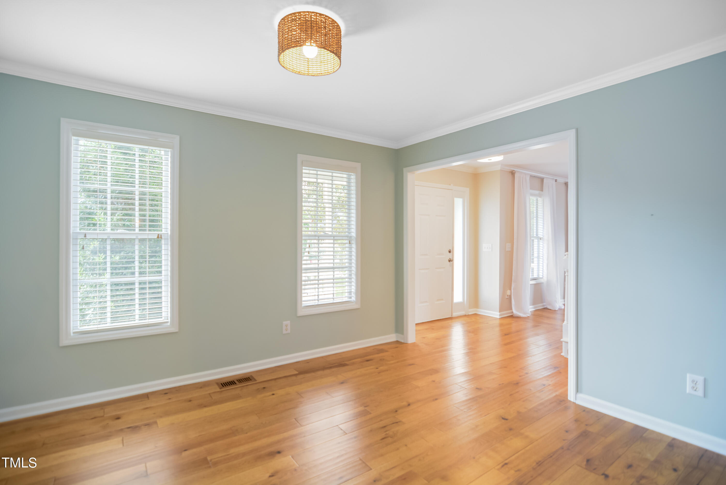 2515 Tryon Pines Drive Raleigh, NC 27603 - Photo 7 of 27 a view of an empty room with wooden floor and a window