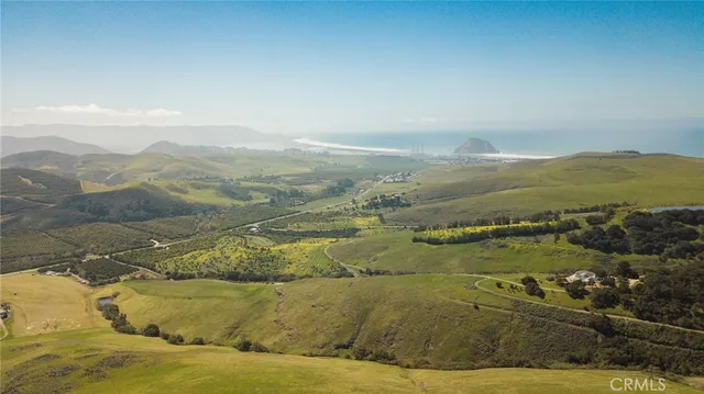 a view of an ocean and mountains