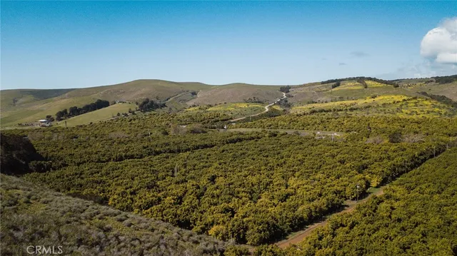 a view of a large building with mountains in the background