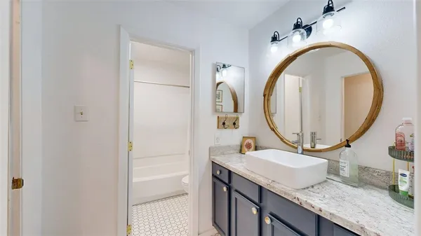 a bathroom with a glass shower door and a shower