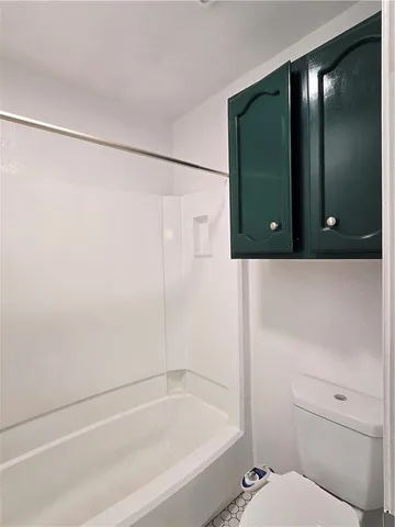 a kitchen with a sink cabinets and wooden floor