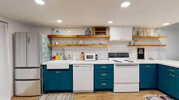 a kitchen with a sink window and cabinets
