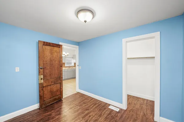 a view of a room with wooden floor and window