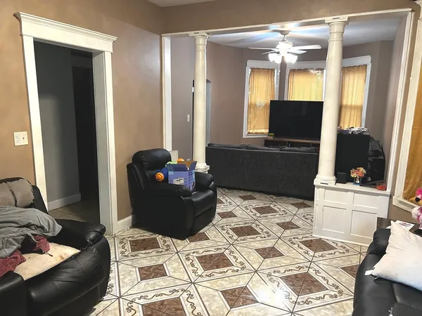 a living room with furniture and a flat screen tv