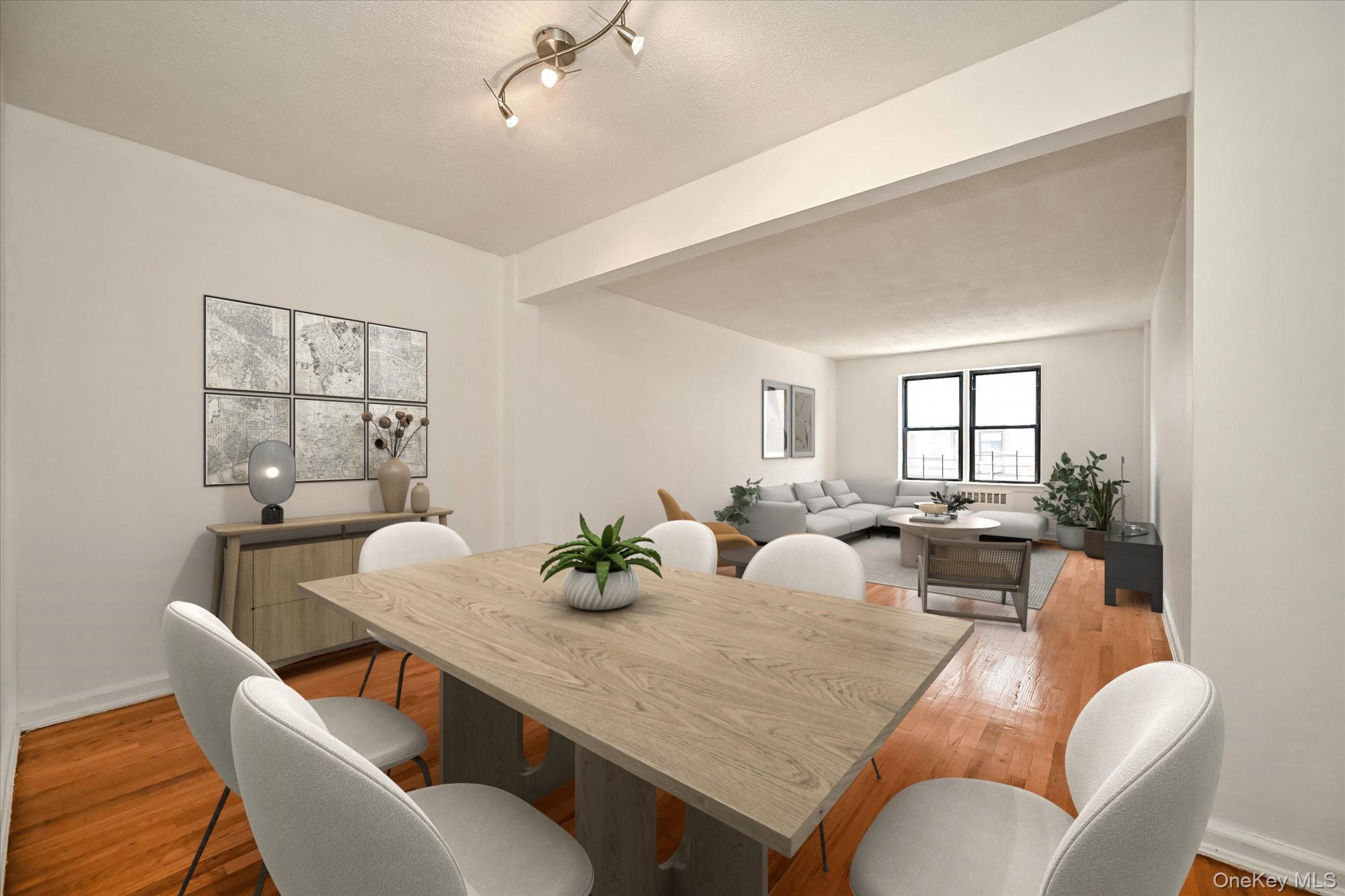 a view of a dining room and livingroom with furniture a large window and wooden floor