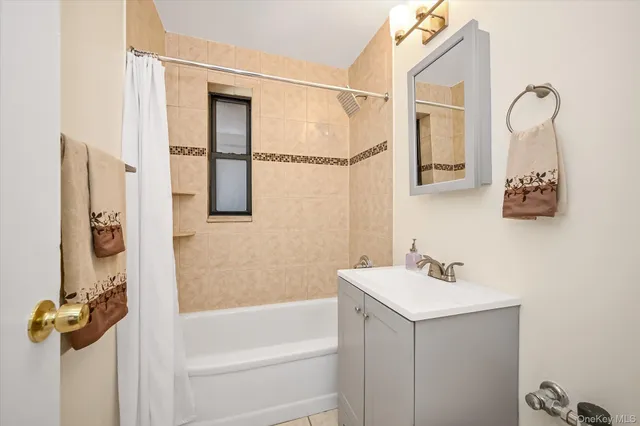 a bathroom with a shower sink and mirror