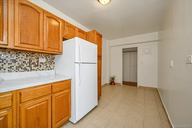 a view of a kitchen with refrigerator and cabinet