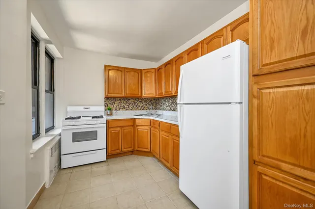 a kitchen with stainless steel appliances granite countertop a refrigerator a stove a sink and dishwasher