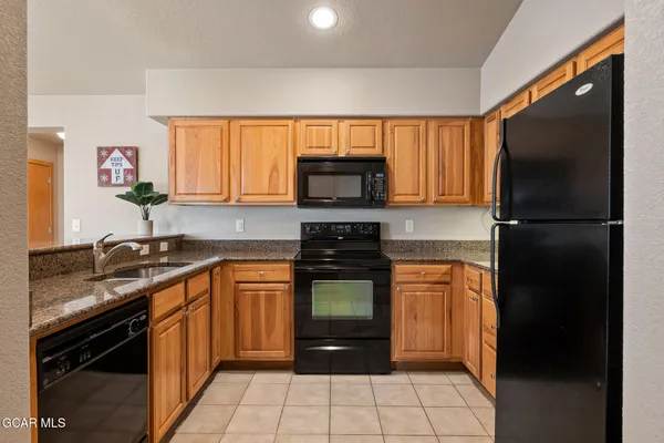 a kitchen with a sink stove and refrigerator