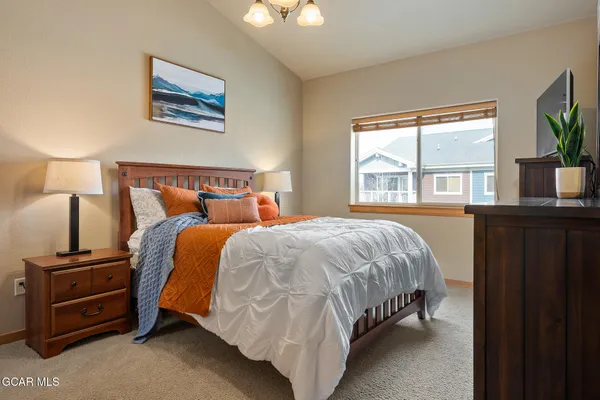 a bed sitting in a bedroom next to a window