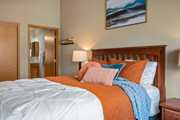 a bedroom with furniture and a lamp