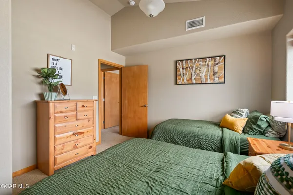 a bedroom with a bed and a dresser
