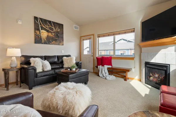 a living room with furniture fireplace and flat screen tv