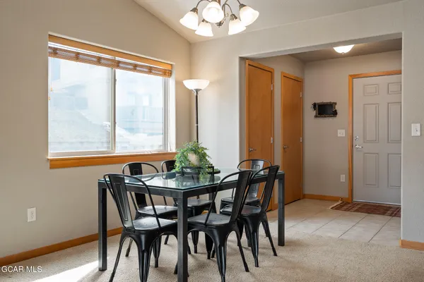 a view of a dining room with furniture and window