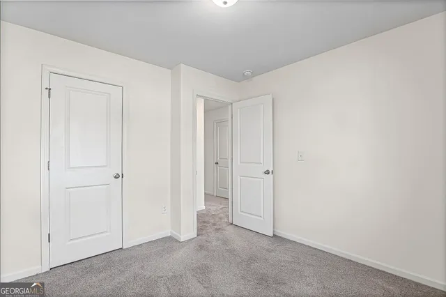an empty room with closet area