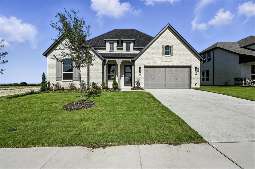 a front view of a house with a garden and plants