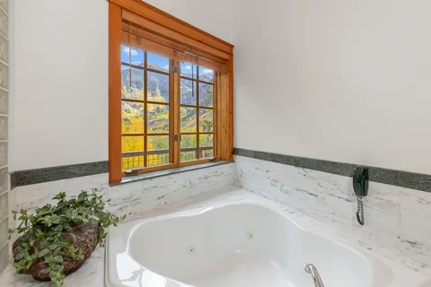 a spacious bedroom with a large bed and a large window