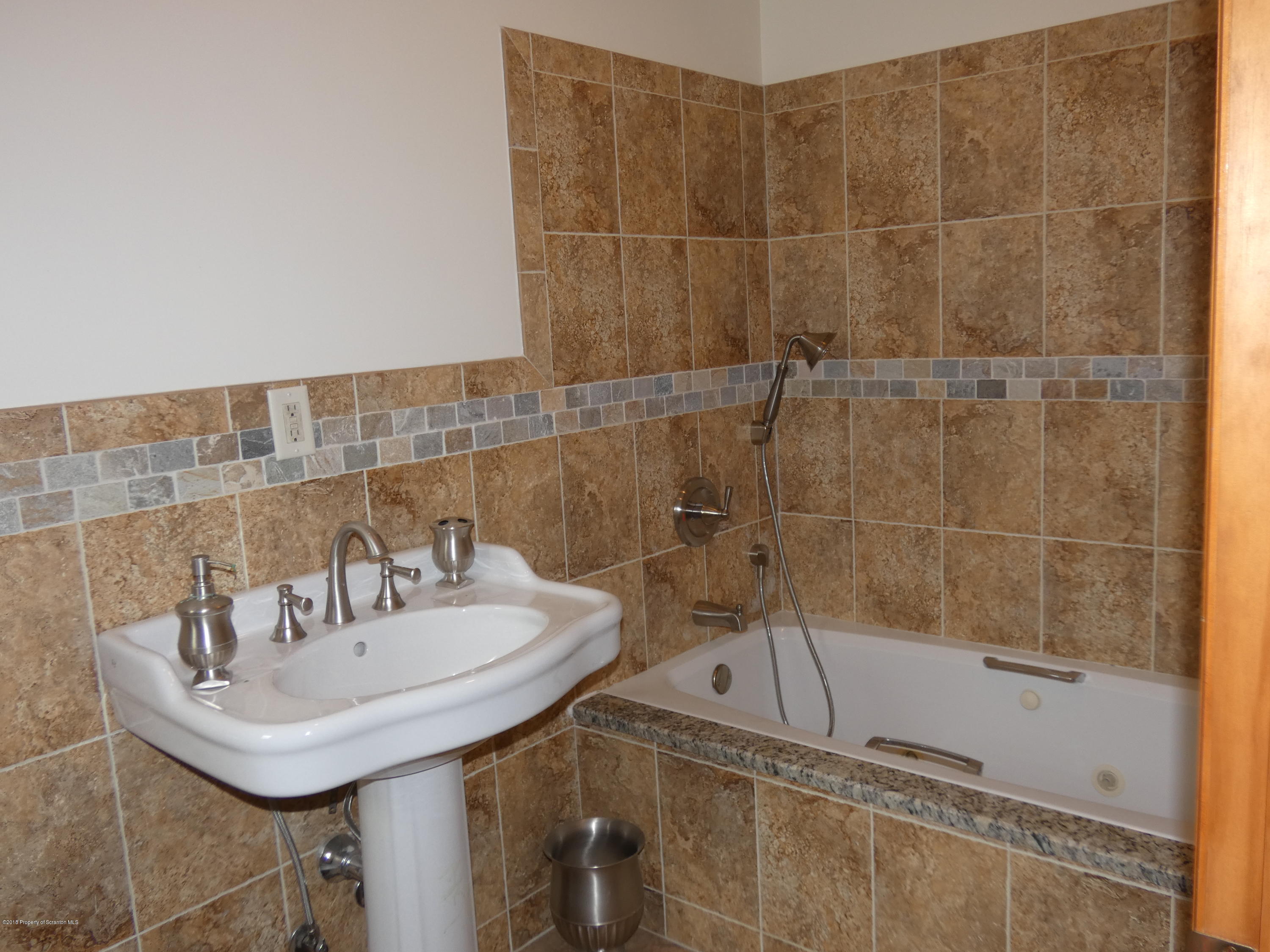 613 Fig Street Scranton, PA 18505 - Photo 12 of 36 a bathroom with a sink and a mirror