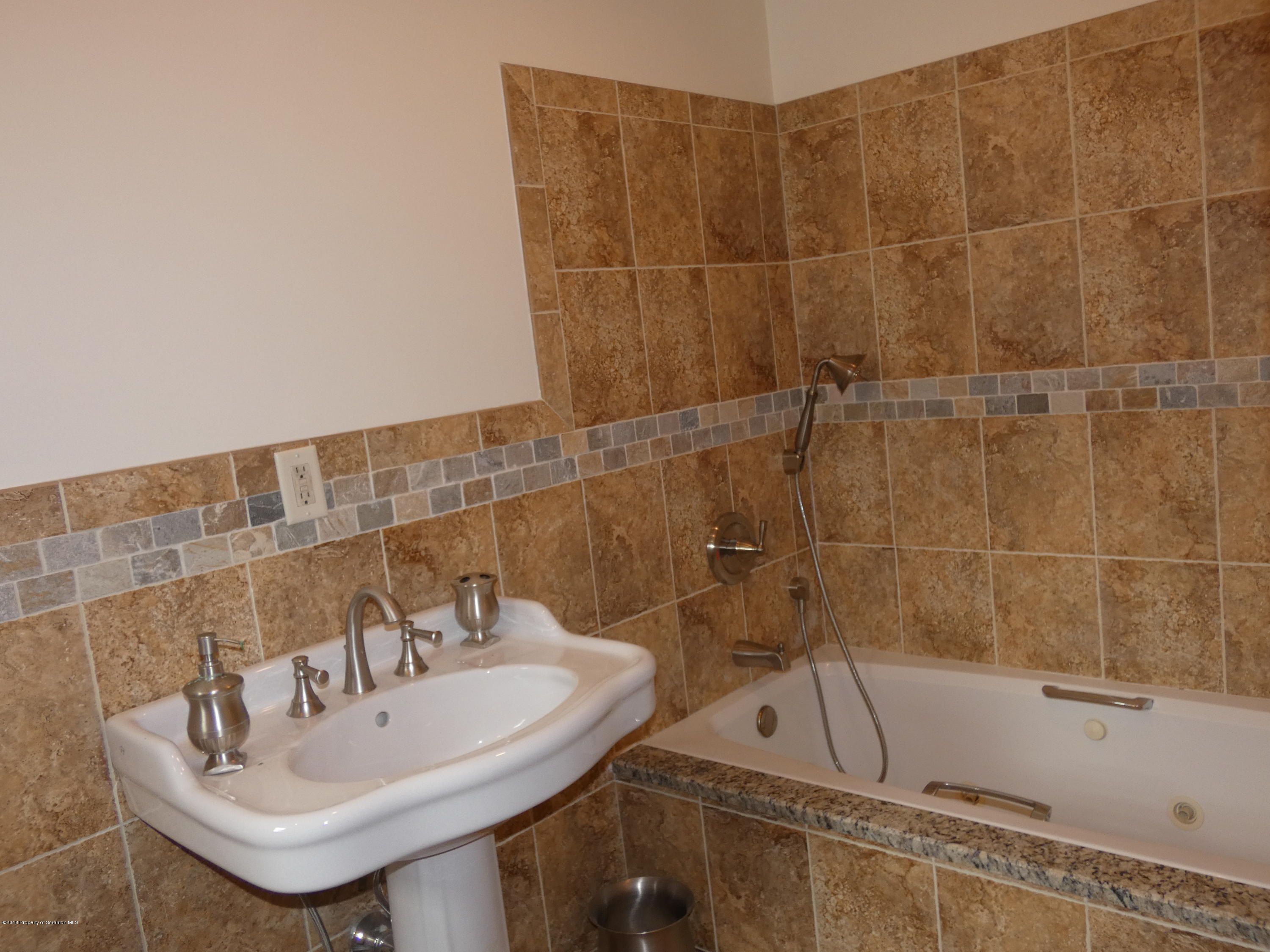 613 Fig Street Scranton, PA 18505 - Photo 14 of 36 a bathroom with a sink and bathtub