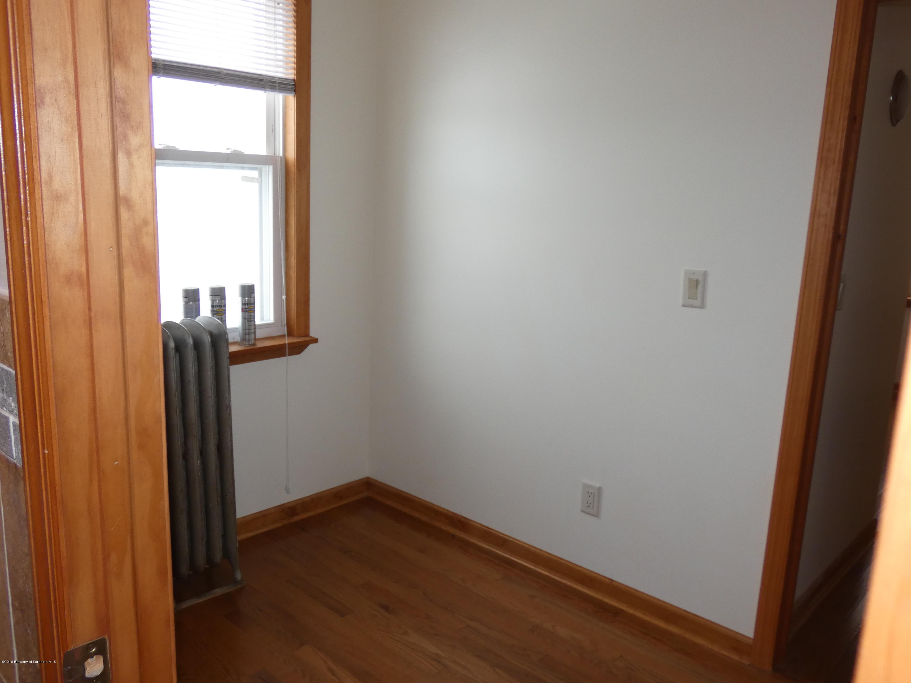 613 Fig Street Scranton, PA 18505 - Photo 16 of 36 an empty room with wooden floor and windows