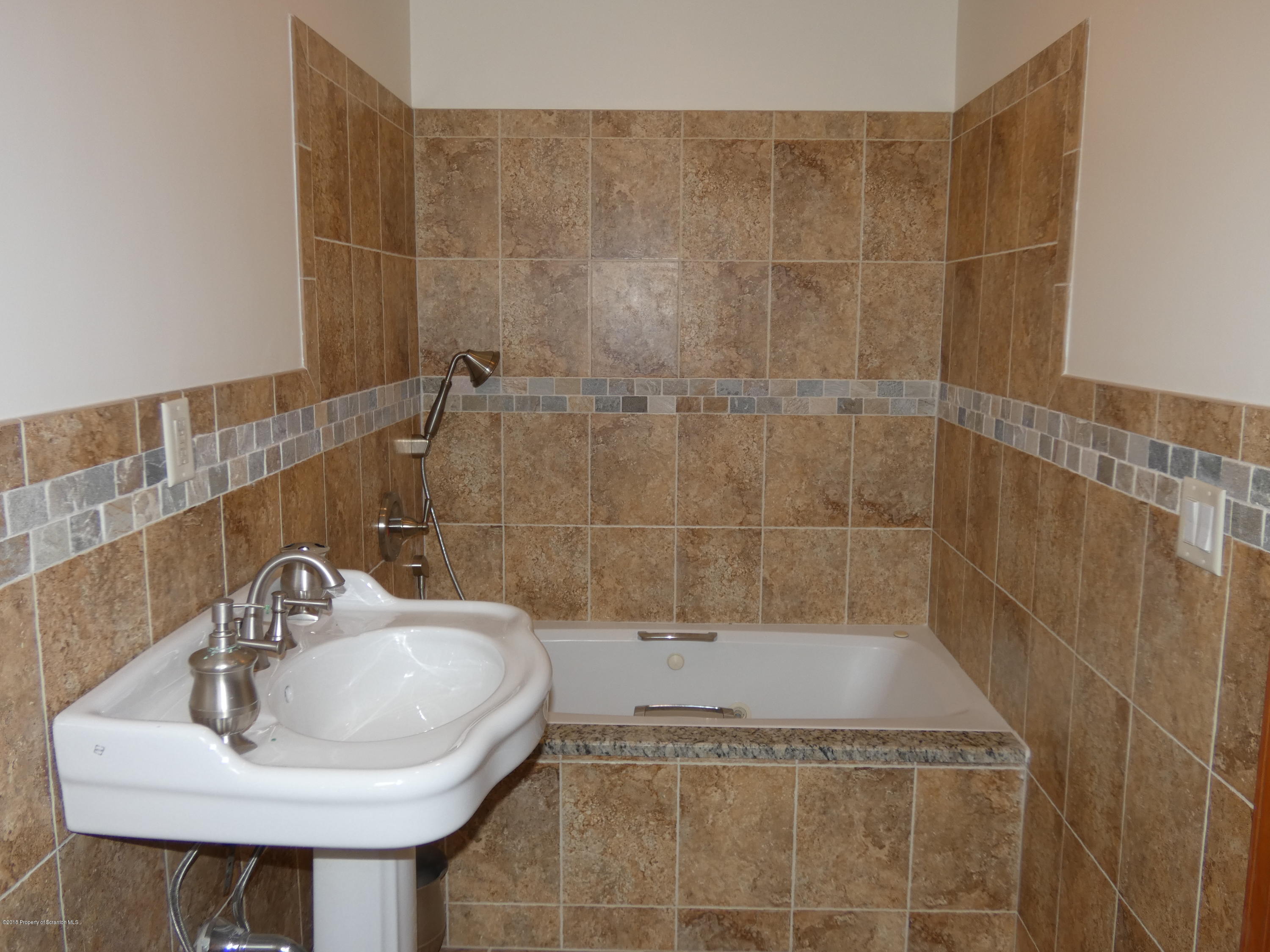 613 Fig Street Scranton, PA 18505 - Photo 17 of 36 a bathroom with a sink and a bathtub