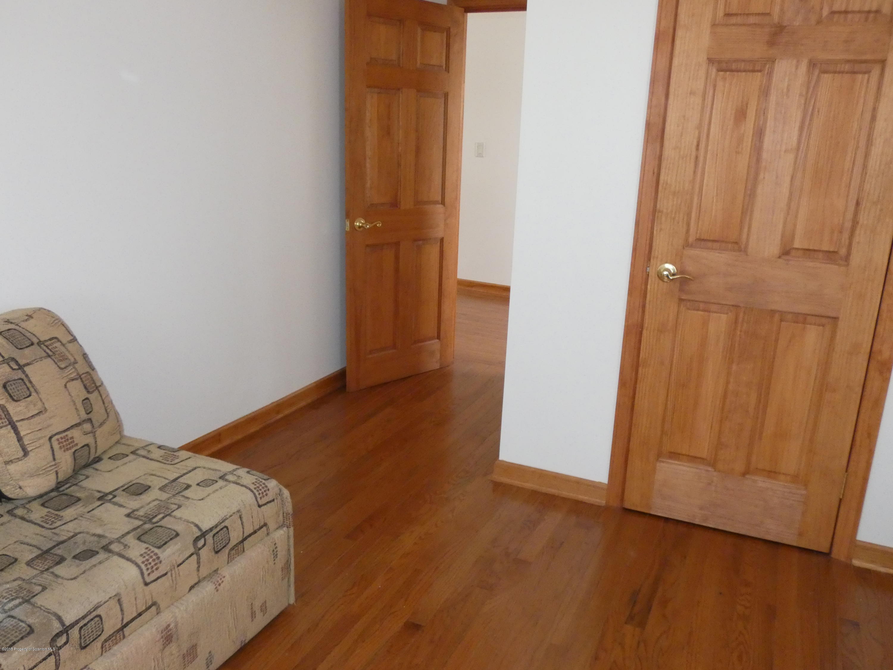 613 Fig Street Scranton, PA 18505 - Photo 19 of 36 a bedroom with a bed and wooden floor