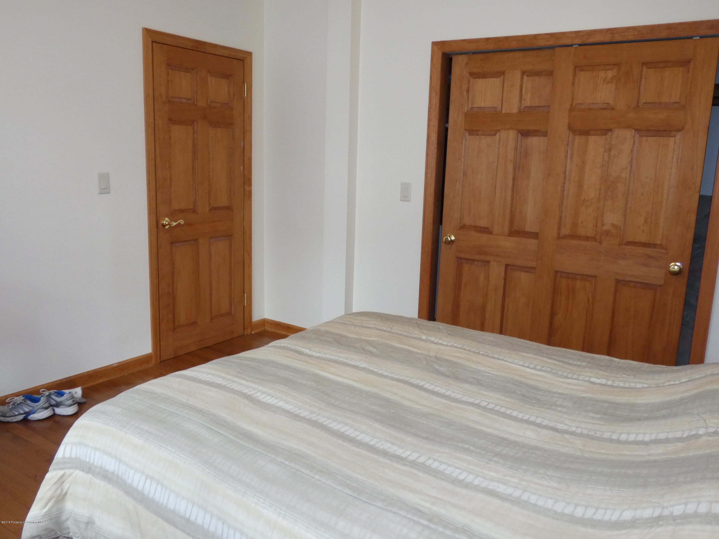 613 Fig Street Scranton, PA 18505 - Photo 20 of 36 a bed room with a bed and a mirror