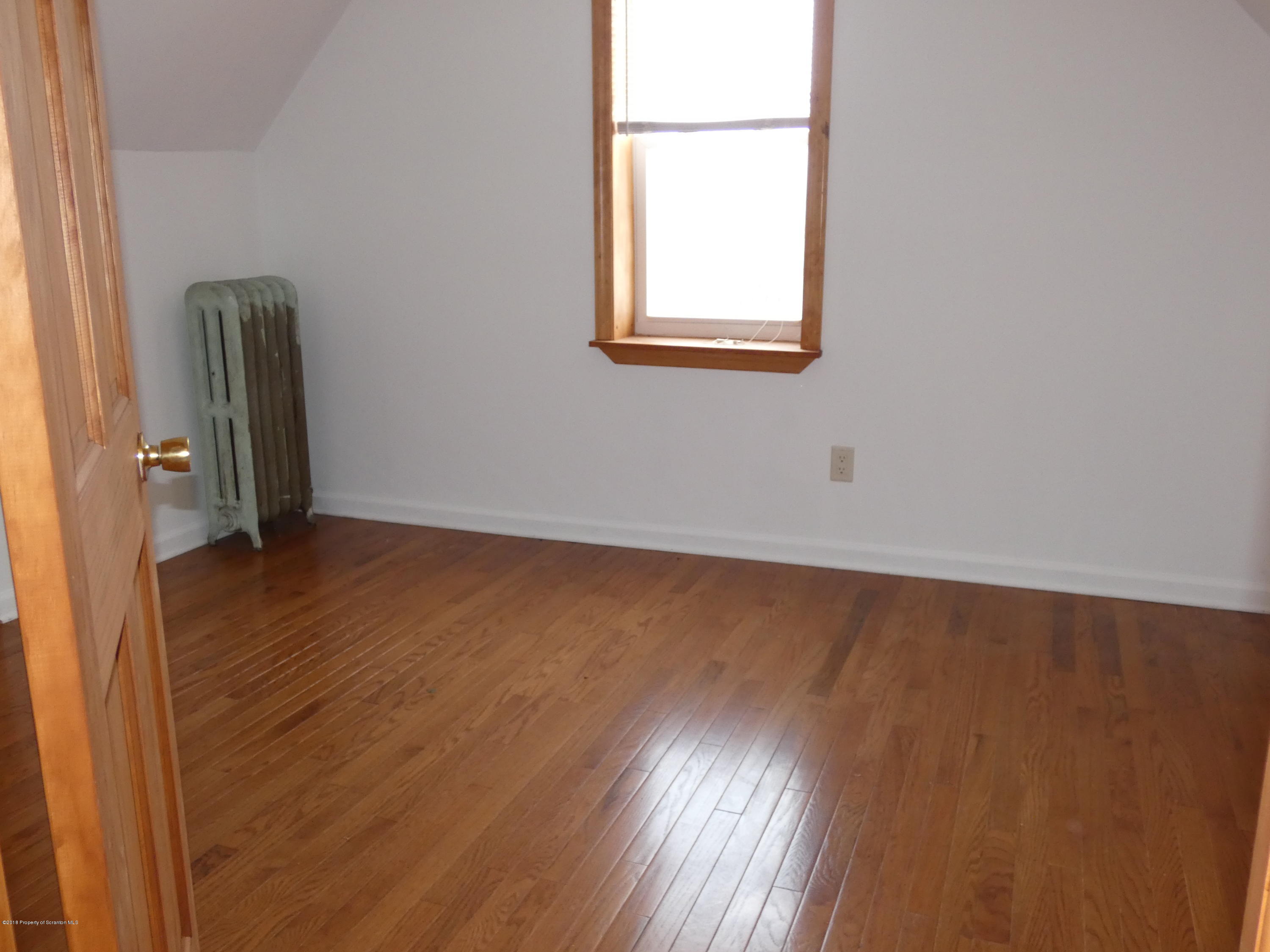 613 Fig Street Scranton, PA 18505 - Photo 23 of 36 an empty room with wooden floor and windows