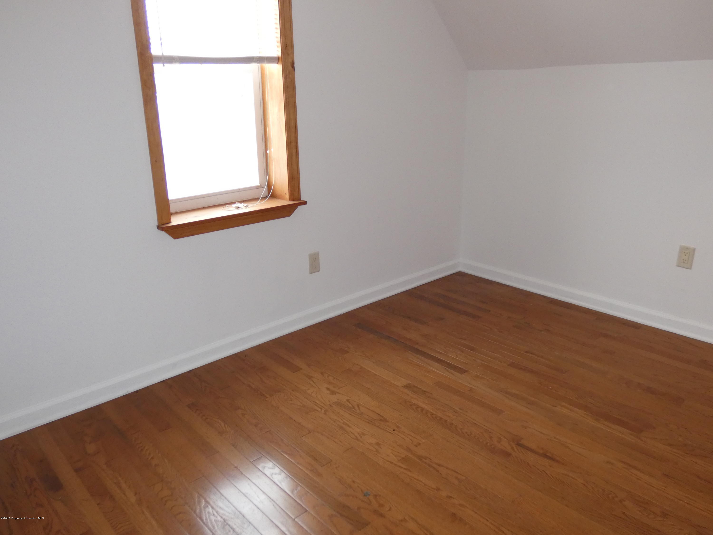 613 Fig Street Scranton, PA 18505 - Photo 24 of 36 an empty room with wooden floor and a window