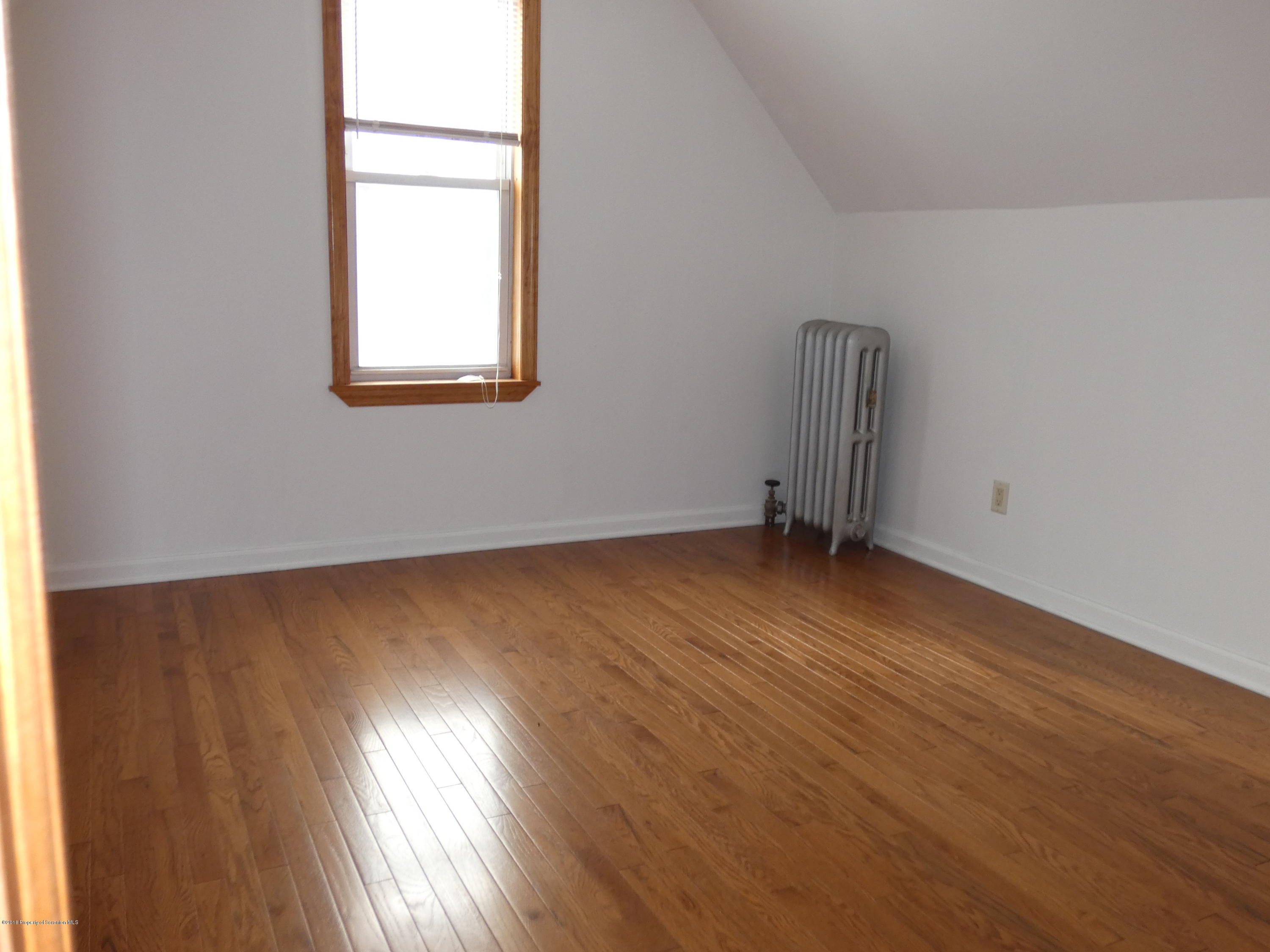 613 Fig Street Scranton, PA 18505 - Photo 25 of 36 an empty room with wooden floor and windows