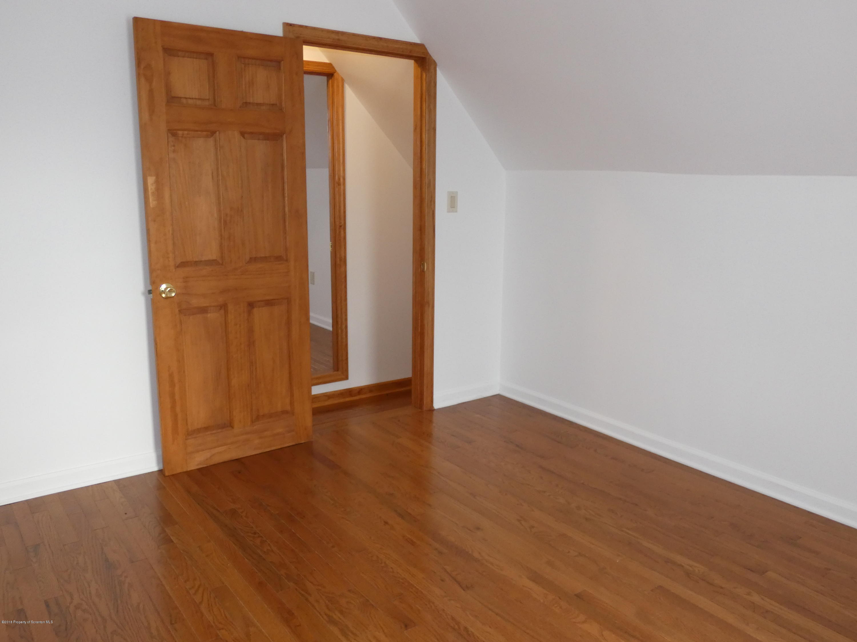 613 Fig Street Scranton, PA 18505 - Photo 26 of 36 an empty room with wooden floor and closet area