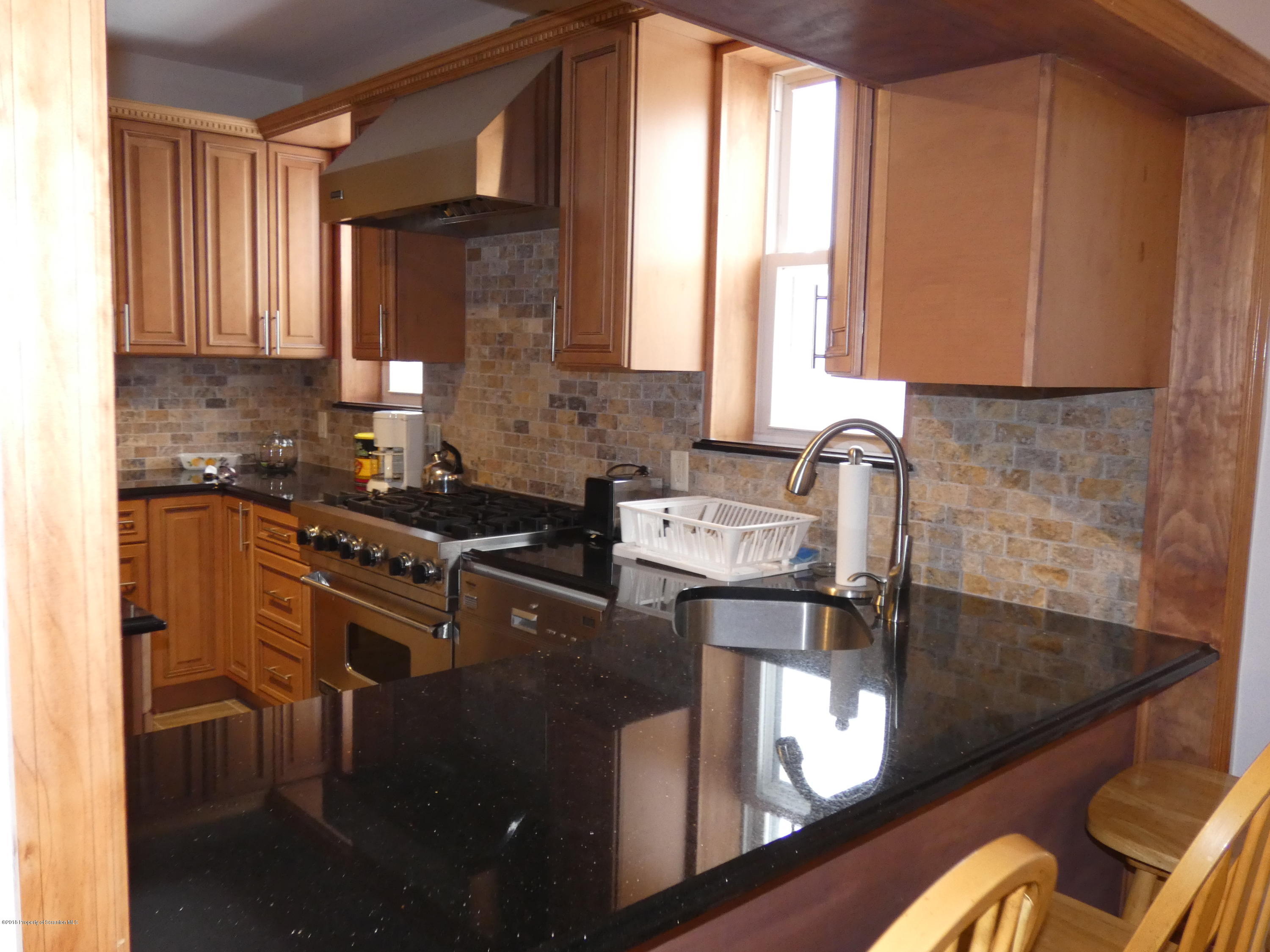 613 Fig Street Scranton, PA 18505 - Photo 4 of 36 a kitchen with stainless steel appliances granite countertop sink stove and cabinets