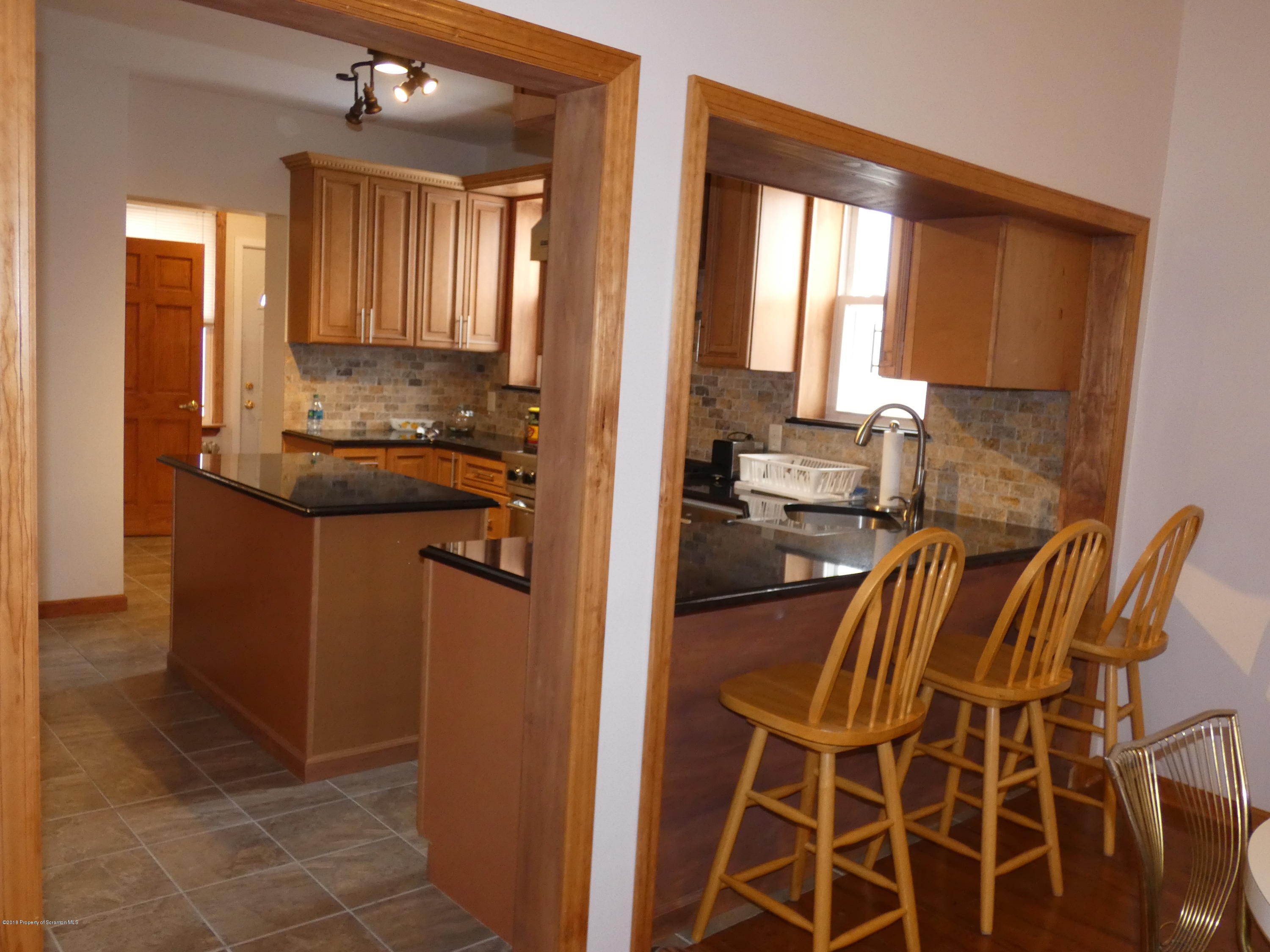 613 Fig Street Scranton, PA 18505 - Photo 8 of 36 a kitchen with a sink and a refrigerator